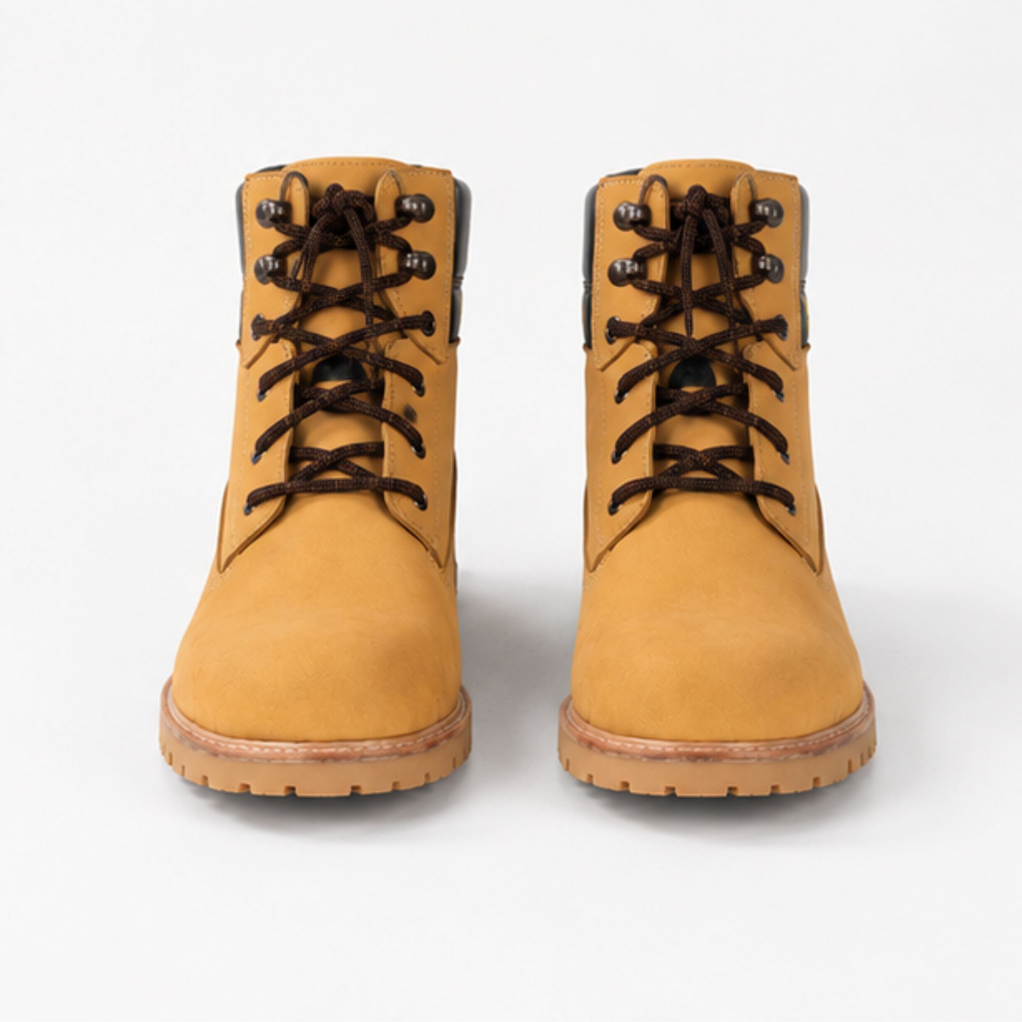 A pair of classic tan suede lace-up boots with dark brown laces and metal eyelets, shown from a front-facing perspective on a light gray background.