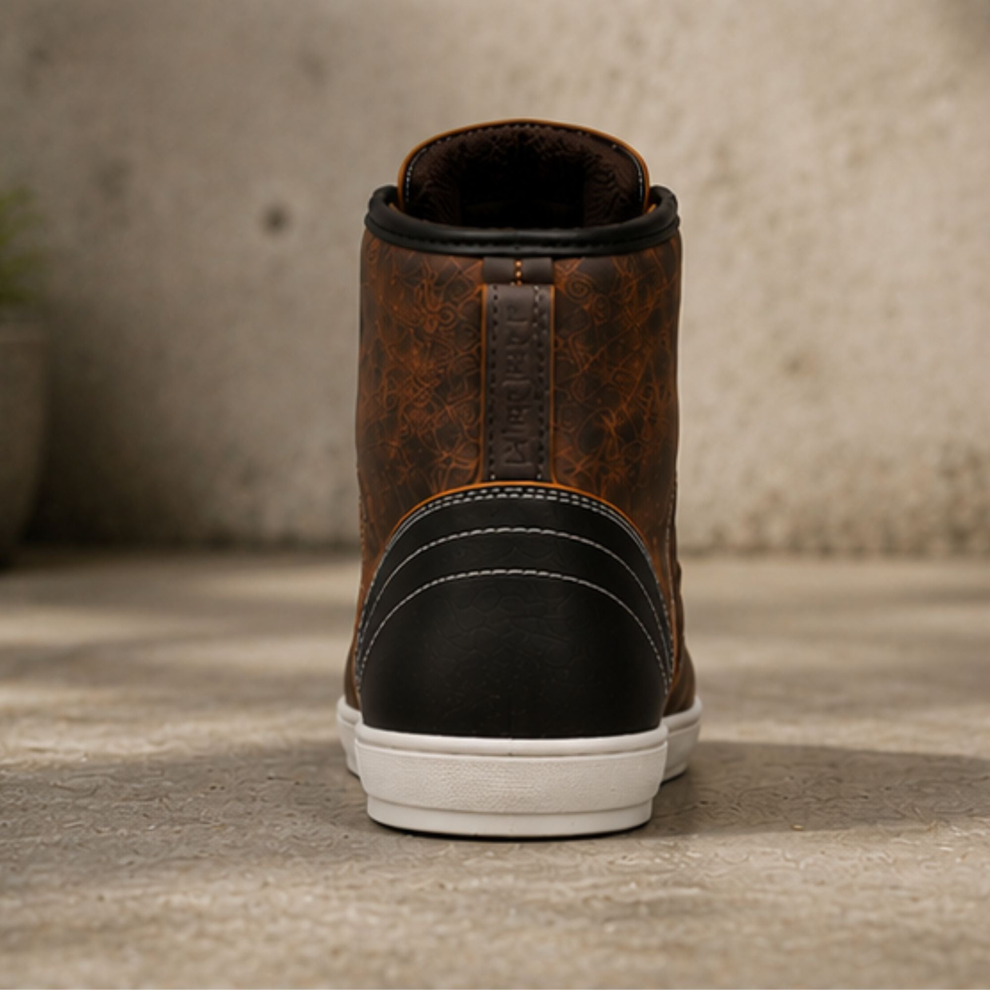 A single brown high-top sneaker shown from the back, featuring a distressed brown leather upper, a black heel counter, white stitching, and a white rubber sole, set against a textured concrete background.